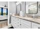 Bathroom boasts granite counters, double sinks, and rectangular mirrors; bedroom view shown in background at 554 Tidewater Chase Ln, Summerville, SC 29486
