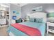 Bedroom showcases a desk, bed with blue bedding, and artwork; bathroom in background at 554 Tidewater Chase Ln, Summerville, SC 29486