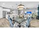 Open-concept dining room and kitchen area with stainless steel appliances and island at 554 Tidewater Chase Ln, Summerville, SC 29486