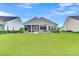 Exterior view of backyard and screened-in porch, perfect for relaxation and outdoor entertaining at 554 Tidewater Chase Ln, Summerville, SC 29486