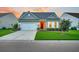 Charming single-story home featuring a well-manicured lawn, a red front door, and an attached two-car garage at 554 Tidewater Chase Ln, Summerville, SC 29486