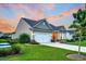 Single-Gathering home with tidy landscaping, attached garage, and a welcoming driveway offers a peaceful curb appeal at 554 Tidewater Chase Ln, Summerville, SC 29486