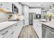 Bright kitchen with stainless steel appliances, white cabinets, subway tile backsplash, and quartz counters at 554 Tidewater Chase Ln, Summerville, SC 29486