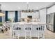 Bright kitchen boasts a large center island with seating, stainless steel appliances, and custom cabinetry at 554 Tidewater Chase Ln, Summerville, SC 29486