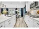 Modern kitchen with stainless appliances, gas range, white cabinets, and view of dining area at 554 Tidewater Chase Ln, Summerville, SC 29486