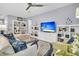 Cozy living room with built-in bookshelves, ceiling fan, and comfortable seating at 554 Tidewater Chase Ln, Summerville, SC 29486