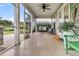 Relaxing screened-in porch with comfortable seating and a ceiling fan overlooking manicured backyard at 554 Tidewater Chase Ln, Summerville, SC 29486