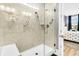 Tiled shower features a glass door, shower bench, grab bars, and adjustable shower head at 554 Tidewater Chase Ln, Summerville, SC 29486