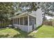 Cozy backyard featuring a screened porch, fenced yard, and lush green lawn for outdoor enjoyment at 623 Bay Tree Ct, Mount Pleasant, SC 29464