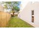 Wide shot of backyard with privacy fence, door to screened porch, and a well-manicured lawn at 623 Bay Tree Ct, Mount Pleasant, SC 29464