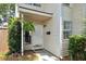 Inviting entrance with a hanging fern, white door, and well-manicured greenery at 623 Bay Tree Ct, Mount Pleasant, SC 29464