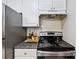 Close-up of kitchen with stone counter top, white subway tile back splash and black stove top at 623 Bay Tree Ct, Mount Pleasant, SC 29464