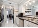 Galley-style kitchen with white cabinets, stainless steel appliances, and ample lighting at 623 Bay Tree Ct, Mount Pleasant, SC 29464