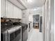 Well-lit laundry room featuring modern washer/dryer units and white cabinets at 623 Bay Tree Ct, Mount Pleasant, SC 29464