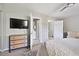 Bright main bedroom featuring a mounted TV, a ceiling fan, and a charming blue and wood dresser at 623 Bay Tree Ct, Mount Pleasant, SC 29464