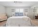 This bright main bedroom features a ceiling fan, two shelves, and a comfy chair for relaxation at 623 Bay Tree Ct, Mount Pleasant, SC 29464