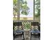 Charming screened porch with chairs and a small table creating an inviting outdoor relaxation space at 623 Bay Tree Ct, Mount Pleasant, SC 29464
