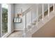 Carpeted staircase with white railing next to a bright window and decorations creating a welcoming space at 623 Bay Tree Ct, Mount Pleasant, SC 29464