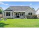 Well-maintained backyard with lush green lawn and covered patio, perfect for outdoor entertaining at 644 Grassy Hill Rd, Summerville, SC 29483
