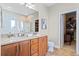 Bathroom featuring double sinks, spacious vanity, tile flooring, and a walk-in closet entrance for storage at 644 Grassy Hill Rd, Summerville, SC 29483