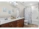 Bathroom with double sink vanity, decorative mirror, shower, and tub combination at 644 Grassy Hill Rd, Summerville, SC 29483