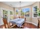 Bright dining area with large windows, wood floors, and easy access to the outdoor patio at 644 Grassy Hill Rd, Summerville, SC 29483