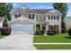 Charming two-story home with a manicured lawn, attached garage, and beautiful landscaping in a suburban neighborhood at 644 Grassy Hill Rd, Summerville, SC 29483
