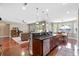 Open-concept kitchen with stainless steel appliances, island with sink, and seamless integration with the living area at 644 Grassy Hill Rd, Summerville, SC 29483