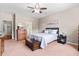 Cozy main bedroom with soft carpet, ceiling fan, and ensuite bathroom for ultimate comfort and privacy at 644 Grassy Hill Rd, Summerville, SC 29483