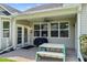 Relaxing covered patio with outdoor seating, a ceiling fan, and serene backyard views for outdoor enjoyment at 644 Grassy Hill Rd, Summerville, SC 29483