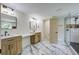 A luxurious bathroom features double sinks, elegant mirrors, and a glass-enclosed shower at 670 Dupre Rd, McClellanville, SC 29458
