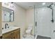 Updated bathroom features a wood vanity, a toilet, and a glass enclosed shower at 670 Dupre Rd, McClellanville, SC 29458