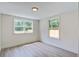 Bright bedroom features large windows offering natural light and backyard views at 670 Dupre Rd, McClellanville, SC 29458
