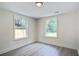 Cozy bedroom with dual windows boasts ample sunlight, showcasing exterior at 670 Dupre Rd, McClellanville, SC 29458