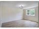 Bedroom with natural light showcases a new window and modern light fixture at 670 Dupre Rd, McClellanville, SC 29458