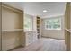 Custom closet with built-in shelving, drawers, and hanging rods provides ample storage with windows to the exterior at 670 Dupre Rd, McClellanville, SC 29458