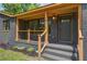 Cozy front porch with stylish railing and tasteful landscaping leading to the front door at 670 Dupre Rd, McClellanville, SC 29458