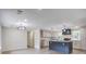 Open-concept kitchen with a central island and modern light fixtures at 670 Dupre Rd, McClellanville, SC 29458
