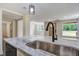 Bright kitchen features marble counters, a modern faucet, and views to the living area at 670 Dupre Rd, McClellanville, SC 29458