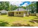 Picture of an expansive backyard with green grass, mature trees and a screen porch at 687 Ponderosa Dr, Charleston, SC 29414