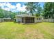 Large backyard featuring a screened in porch, air conditioning unit and verdant lawn at 687 Ponderosa Dr, Charleston, SC 29414