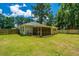 Well-maintained backyard featuring a screen porch and lush, green lawn at 687 Ponderosa Dr, Charleston, SC 29414