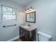 Bathroom featuring a vanity with dark wood cabinet, mirror, and a window at 687 Ponderosa Dr, Charleston, SC 29414