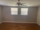 Clean bedroom with ceiling fan, natural light from two windows, wood flooring and neutral walls at 687 Ponderosa Dr, Charleston, SC 29414