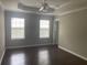 Bright bedroom with tray ceilings, wood floors, neutral walls and ample natural light from two windows at 687 Ponderosa Dr, Charleston, SC 29414