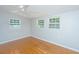 Bedroom featuring hardwood floors and natural light from three windows at 687 Ponderosa Dr, Charleston, SC 29414