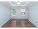 Spacious bedroom with tray ceilings, crown molding, and two bright windows at 687 Ponderosa Dr, Charleston, SC 29414