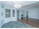 Open-concept dining area with tile flooring, chandelier, and fireplace at 687 Ponderosa Dr, Charleston, SC 29414