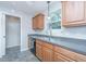 Well-lit kitchen with stainless steel sink, wood cabinets, dishwasher, and durable countertop at 687 Ponderosa Dr, Charleston, SC 29414