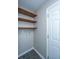 Laundry area with floating wood shelves and utility connections next to white door at 687 Ponderosa Dr, Charleston, SC 29414